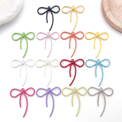 Colorful bow and butterfly charms shown in a close-up product view