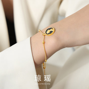 Reversible Cameo and Red Apple Medallion Bracelet in Gold Tone