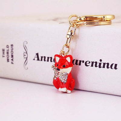 Angled front view of a red fox charm with clear rhinestones and gold-tone hardware.