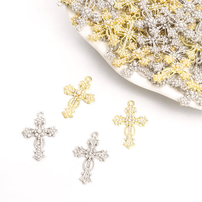 Assorted cross charms arranged on a white surface