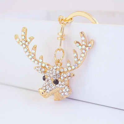Close-up of a gold-tone deer head keychain with clear and iridescent rhinestones.