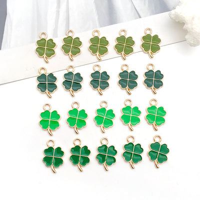 Colorful four-leaf clover and clover charms arranged on a light background