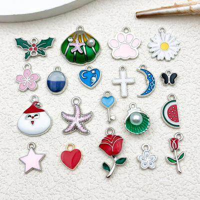 Colorful starfish and leaf charms arranged on a light background