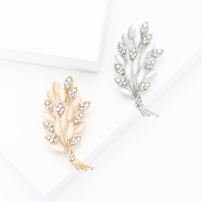 A curved leaf spray with clear crystals shown on a white background