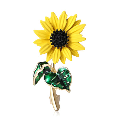 Yellow Enamel Sunflower Brooch With Glossy Green Leaves shown from the front on a white background