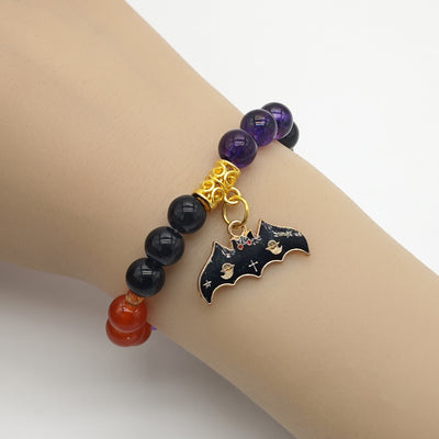 Bat charm multicolor bracelet worn on a mannequin wrist