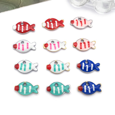 Colorful fish charms arranged on a light background