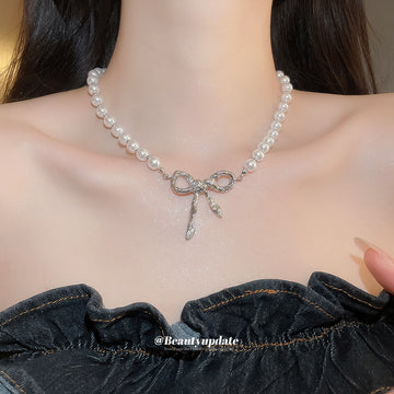 White Pearl Strand Necklace with Silver Tone Bow Center