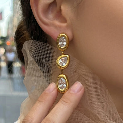 Gold triple irregular zircon drop earring worn on ear with tulle
