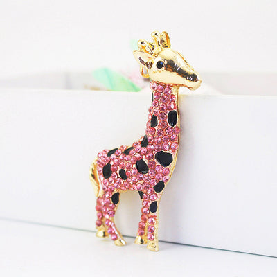 Close view of a pink rhinestone giraffe ornament with black spots.