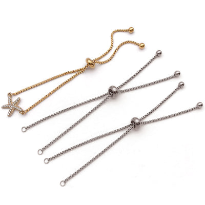 Metallic crimp bead jewelry findings arranged on a light background