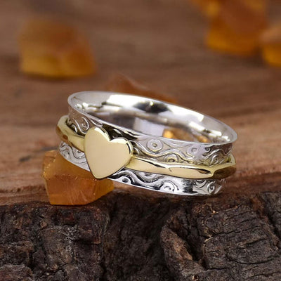 Dual-tone silver gold heart wave band ring on wood with amber stones