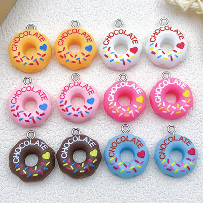Multicolor donut charms arranged on a light background