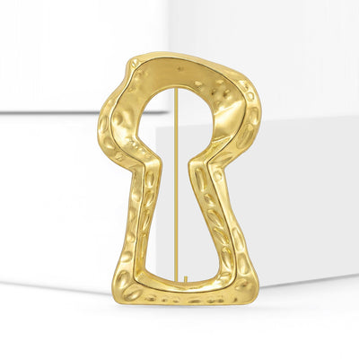 Front view of hammered gold keyhole brooch with open center decorative metal pin