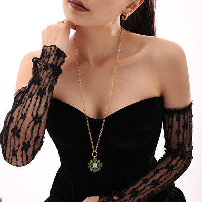 Model wearing green enamel snowflake pendant gold paperclip long necklace