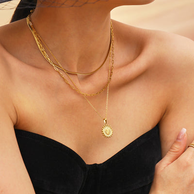 Gold double-layer paperclip and pendant necklace worn on model