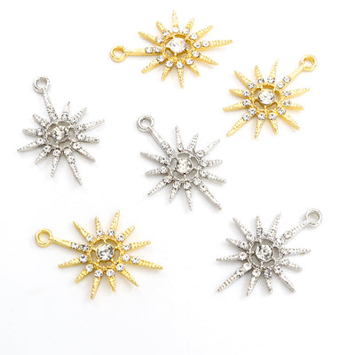 Assorted sunflower charms arranged on a white surface