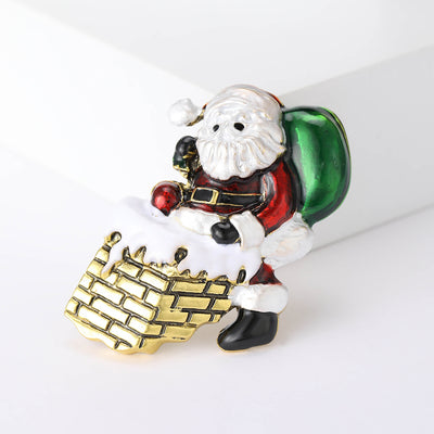 Front view of the enamel santa climbing a brick chimney brooch decorative clothing pin on a white background