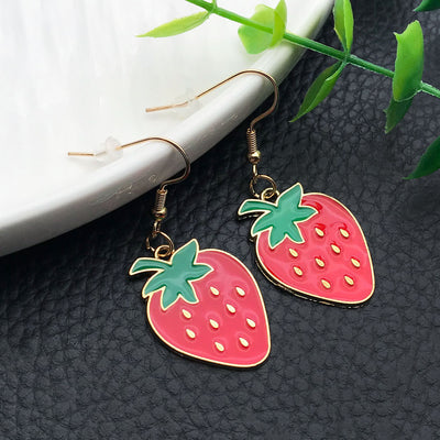 Grouped display of the glossy red strawberry metal hook dangle earring on a jewelry card