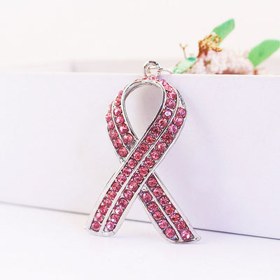 Front view of a silver-tone ribbon charm covered with pink rhinestones.