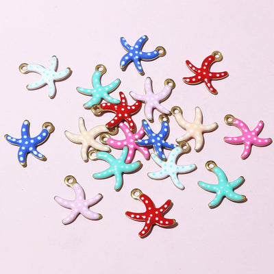 Front overview of colorful enamel starfish charms with gold tone loops arranged on a light background