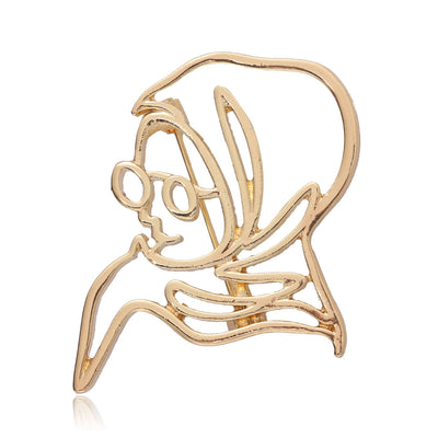 Gold hollow outline portrait face brooch with glasses on white