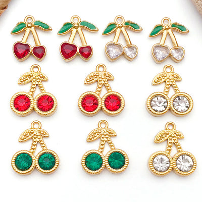 Gold-tone cherry charms arranged on a light background