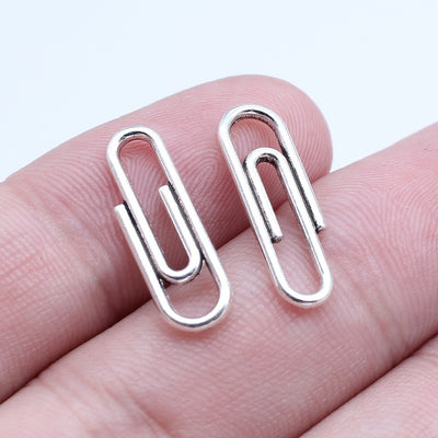 Antique Silver, Bright Silver, Antique Gold paper clip shaped metal charms in image 5, shown in an alternate angle or fi