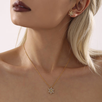 Model wearing gold clear snowflake zircon pendant necklace with matching stud