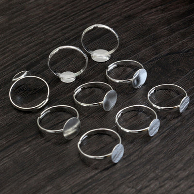small round-pad ring blank assortment on a light background