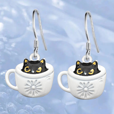 Product view showing black cats peeking from white embossed coffee cups