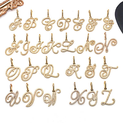 Gold-tone alphabet letter charms arranged on a light background