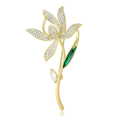 Gold magnolia flower brooch with pavé zircon petals and green leaf