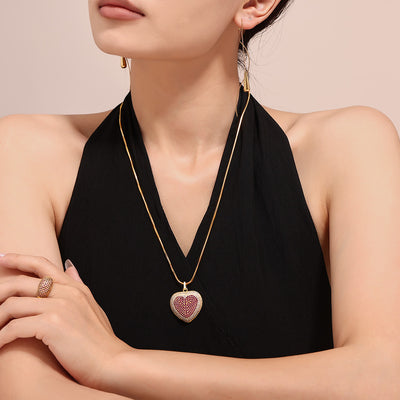 Model in black top wearing gold pink zircon heart pendant necklace