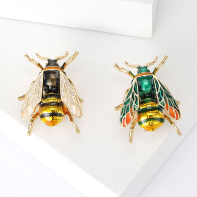 Green and black yellow enamel bee brooches gold tone side by side