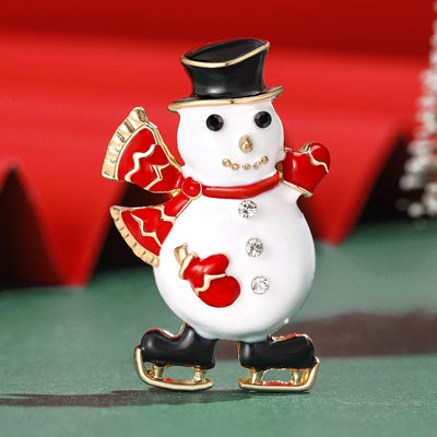 Front view of the enamel snowman brooch with top hat and ice skates decorative clothing pin on a white background