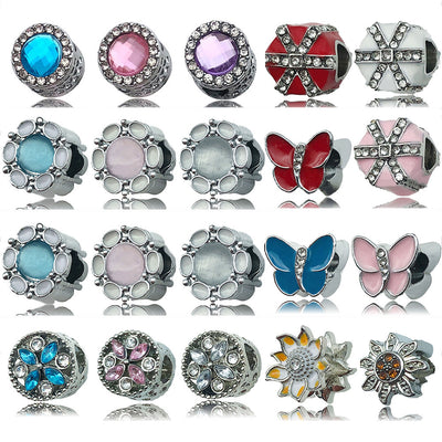 Silver-tone heart and butterfly beads arranged on a light background