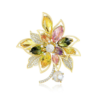 Front view of multicolor crystal flower brooch with clear drop against a white background.