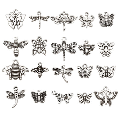 Metallic butterfly and bee charms arranged on a light background