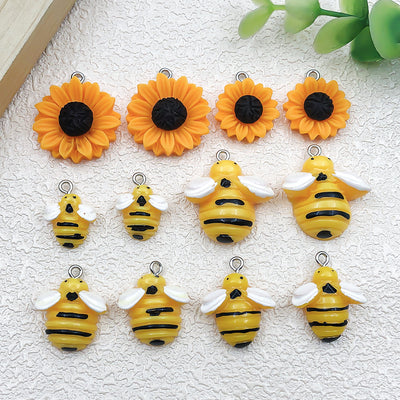 Multicolor sunflower and daisy charms arranged on a light background