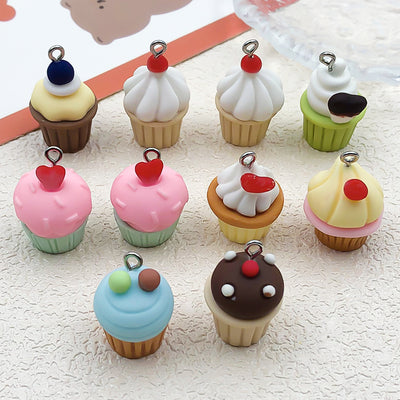 Multicolor cake charms arranged on a light background