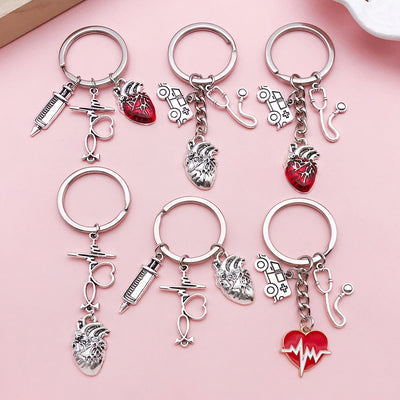 Image 1 showing a bunch of charms on top of a pink surface.