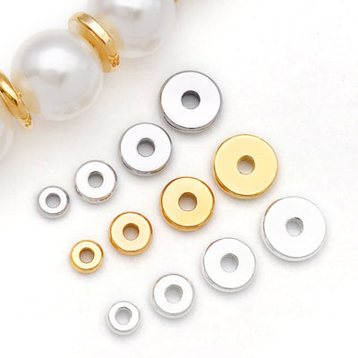 Front overview of flat wheel shape metal spacer discs arranged by finish and size
