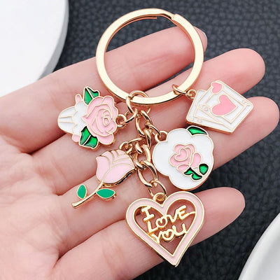 Overview showing the available color and design variations of the pink rose love heart letter and card metal keychain