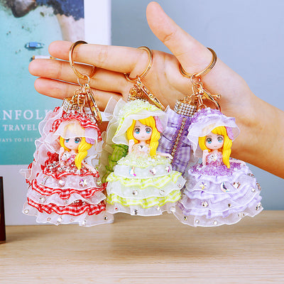 Main image 1 shows a supplied presentation of jeweled bonnet plaid dress doll keychains with visible attached key hardwa