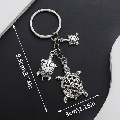 Main display of silver tone three turtle family keychain