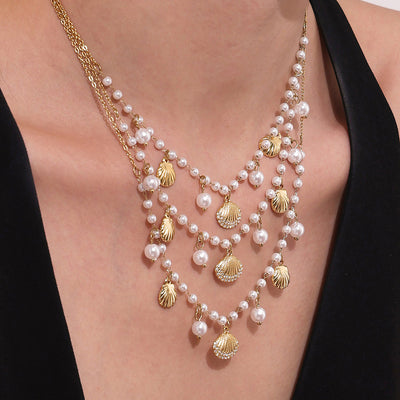 Neckline view of pearl and shell charm necklaces in main image 1.