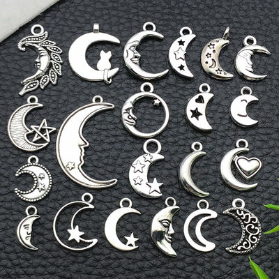 Black moon and sun charms arranged on a light background