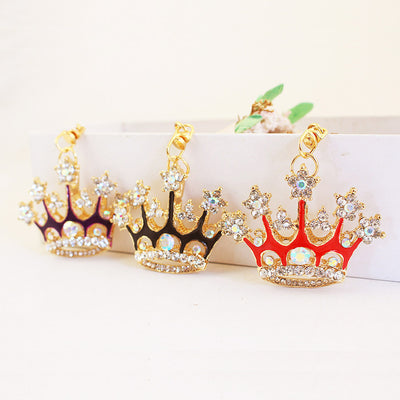 Three crown keychains in red, purple, and black with clear faceted stones and gold-tone clips.