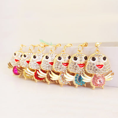 A row of gold-tone winged chick charms displays several colorful round center stones.